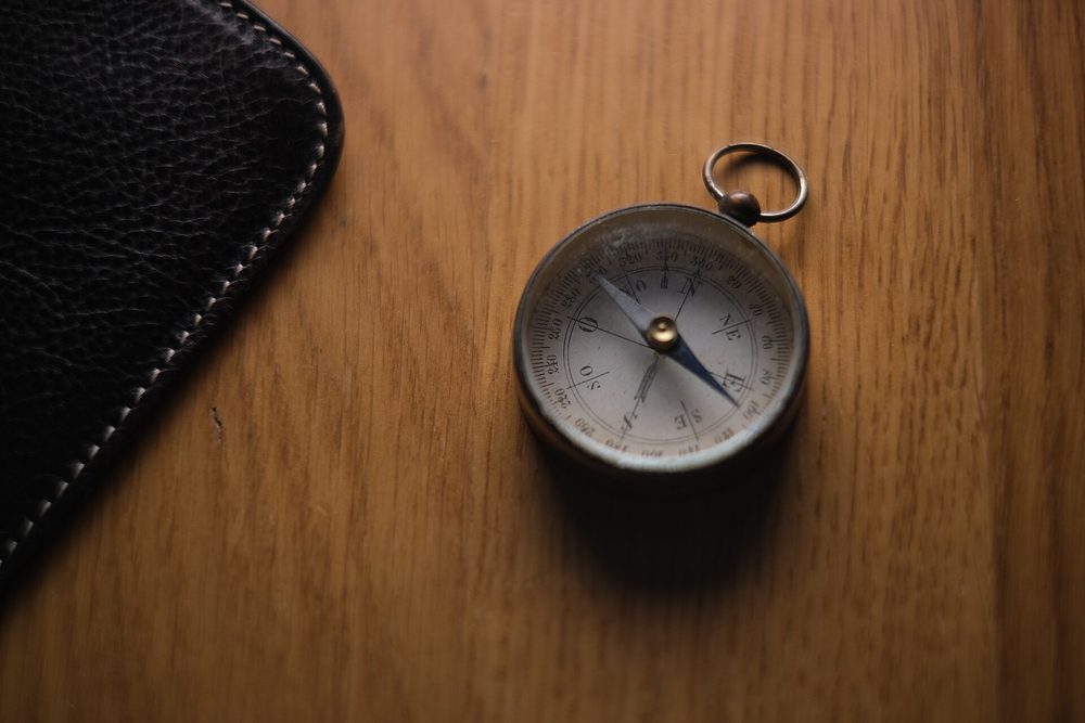 A compass on a wooden table